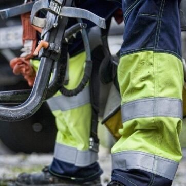 person working in workwear pants with reflective tapes on the pant
