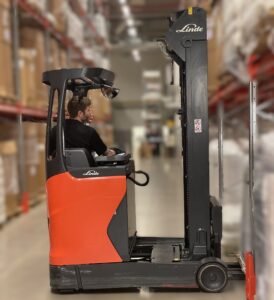 Worker in a warehouse truckdriving