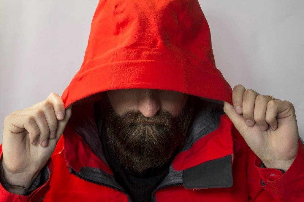 Man hold his rainwear hat